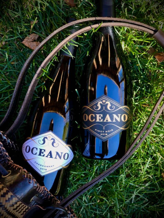 Oceano wine bottle laying in grass
