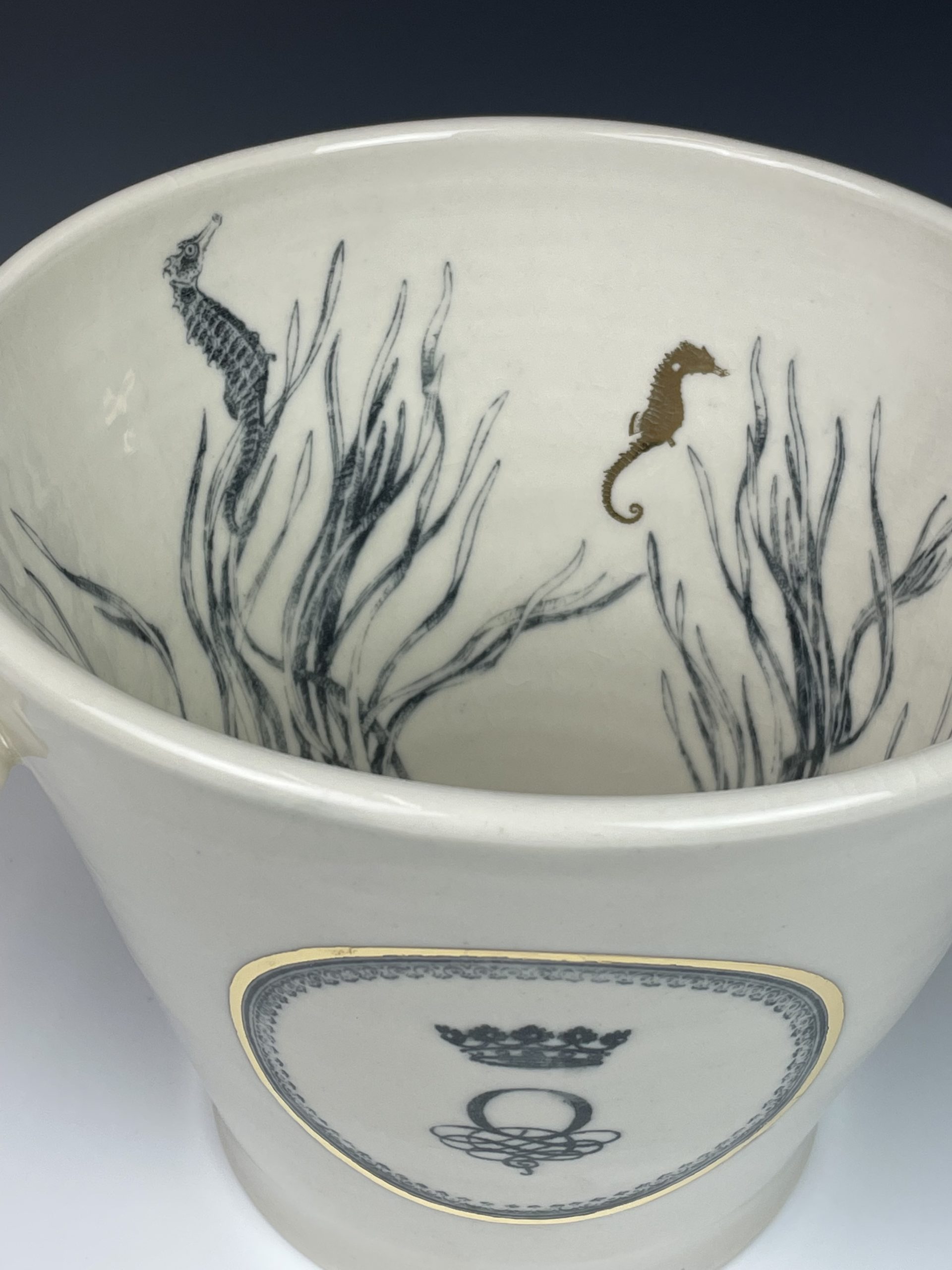 Ocean Wines ice bucket titled forward to show off the interior seahorses and seaweed decorations.
