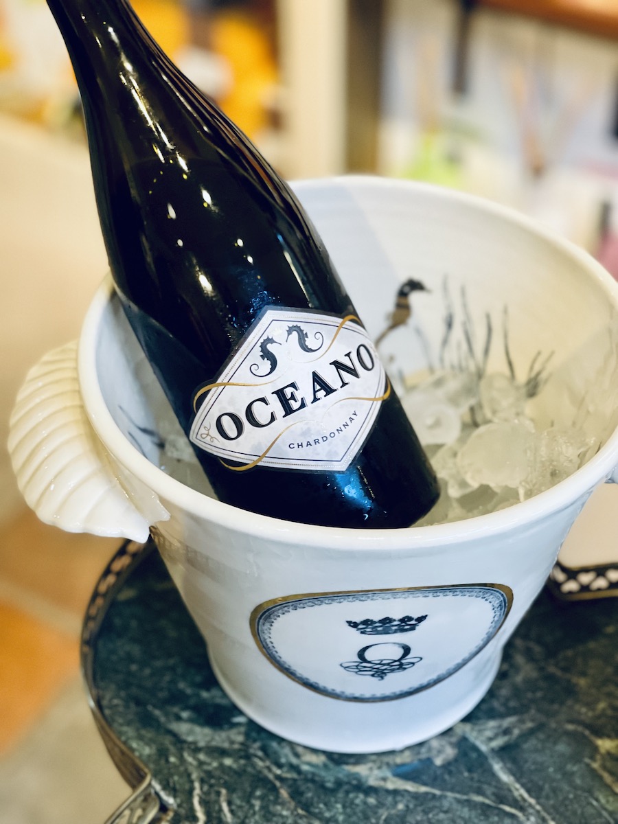 Oceano Wines Chardonnay chilling in custom Oceano ice bucket with seashell handles.