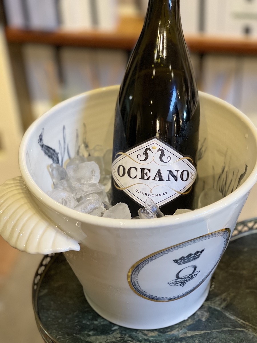 Oceano Wines ice bucket with seashell handles filled with ice and chilling a bottle of Oceano Chardonnay wine.