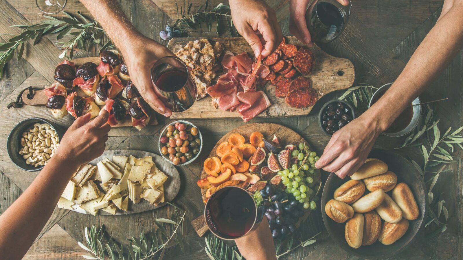 A well-stocked charcuterie board filled with meats, cheeses, and veggies.