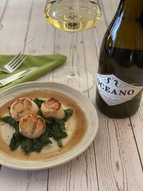 Lemon Zested Diver Scallops served over wilted Spinach