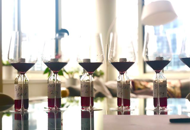 A row of glasses filled with different wine