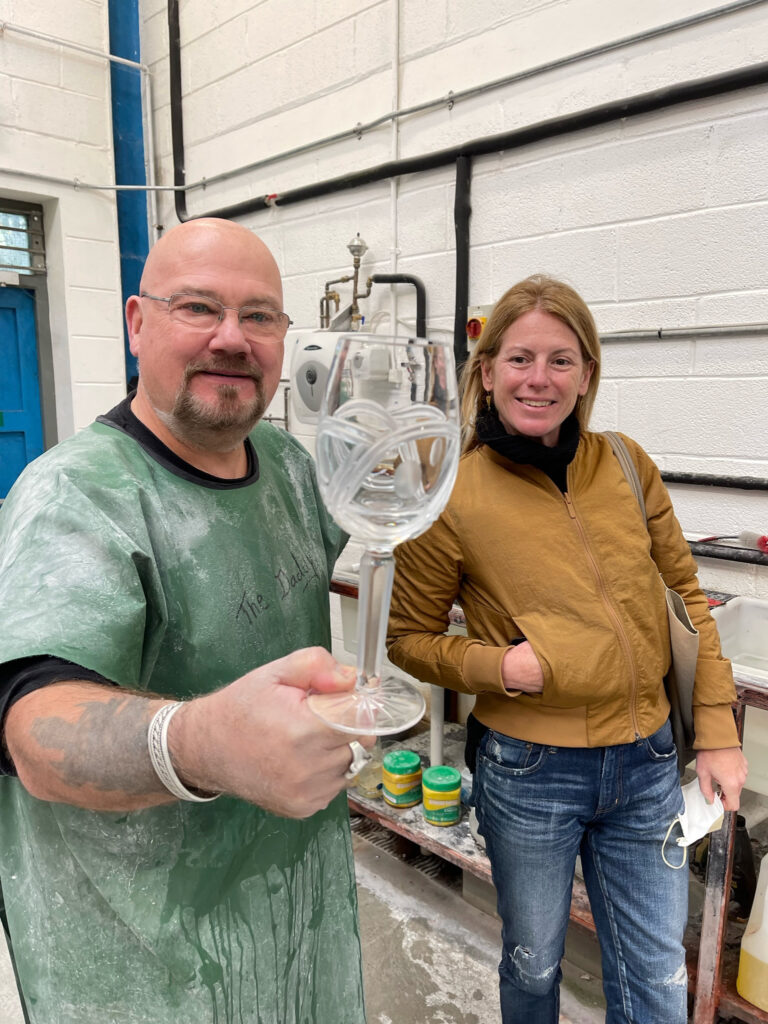 Glassmaker and Rachel Martin displaying newly-made, hand-cut wine glass