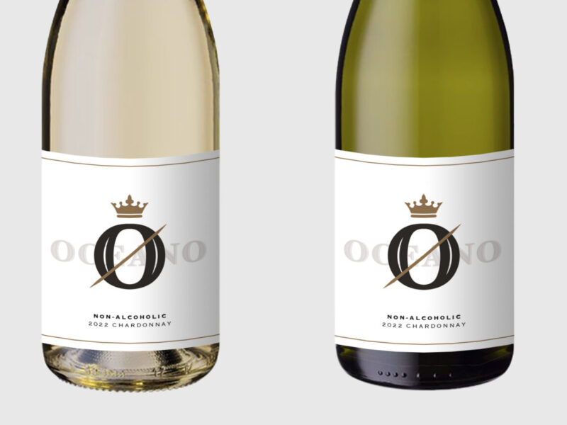 Image of four bottles of wine standing side by side - two show clear or lighter colored bottles that house white white, two show green, darker colored bottles that house red white. The bottoms have labels that show the new Oceano Zero brand of non-alcoholic wines, offered by our California winery and California wine company.