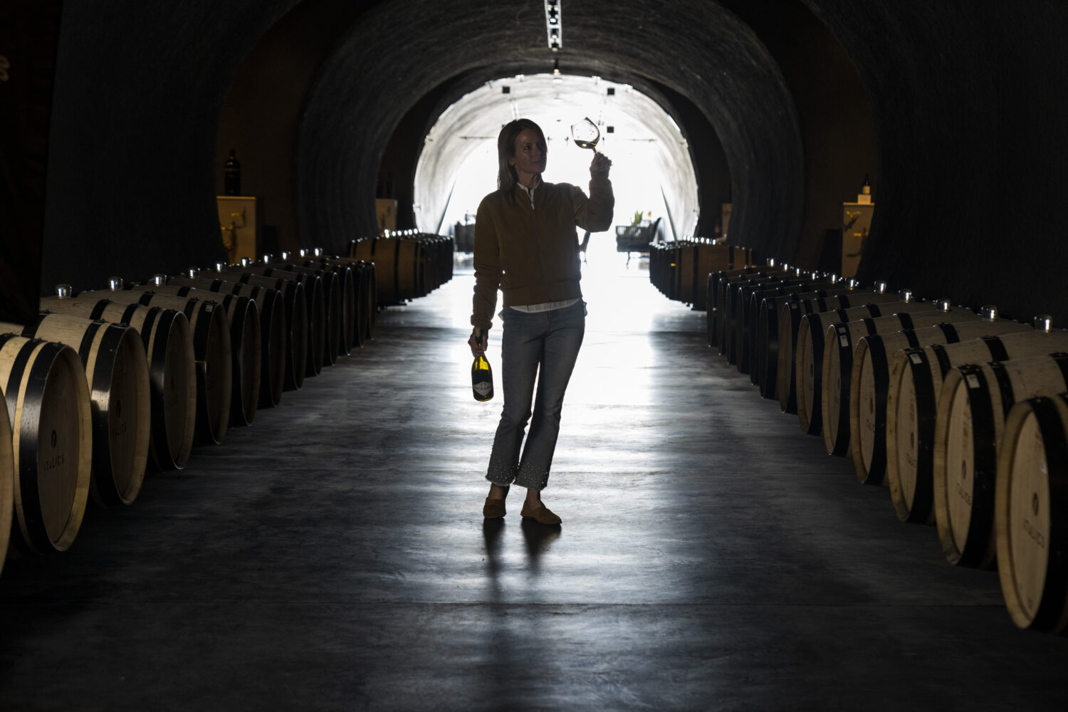 Rachel Martin testing a bottle of oceano wine.