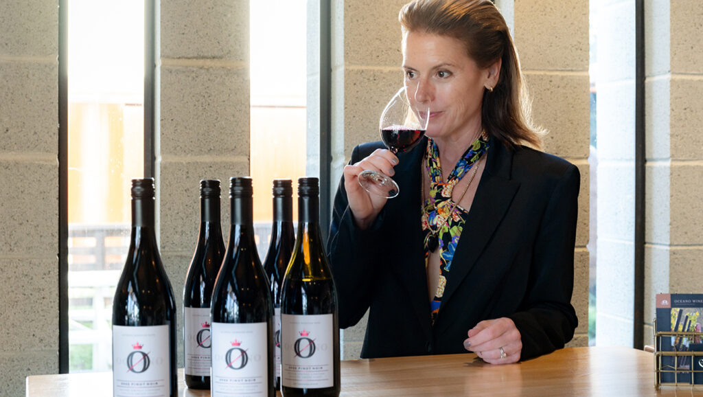 Rachel Martin taste testing a bottle of oceano zero pinot noir.