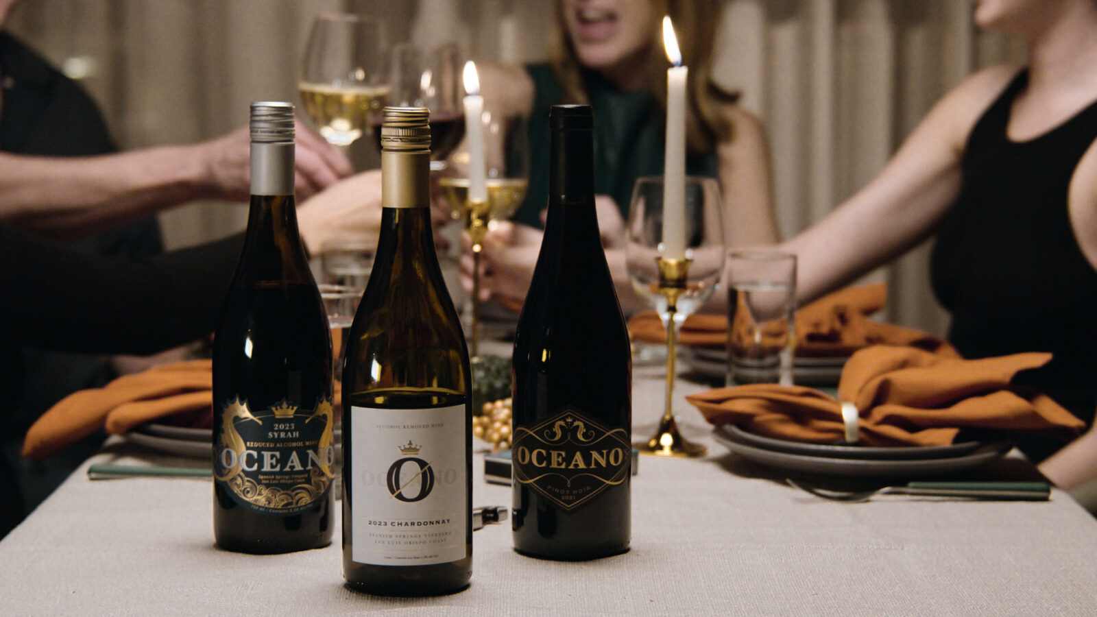 Fall table layered with linens, wood boards, and seasonal produce