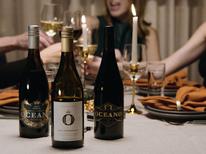 Fall table layered with linens, wood boards, and seasonal produce